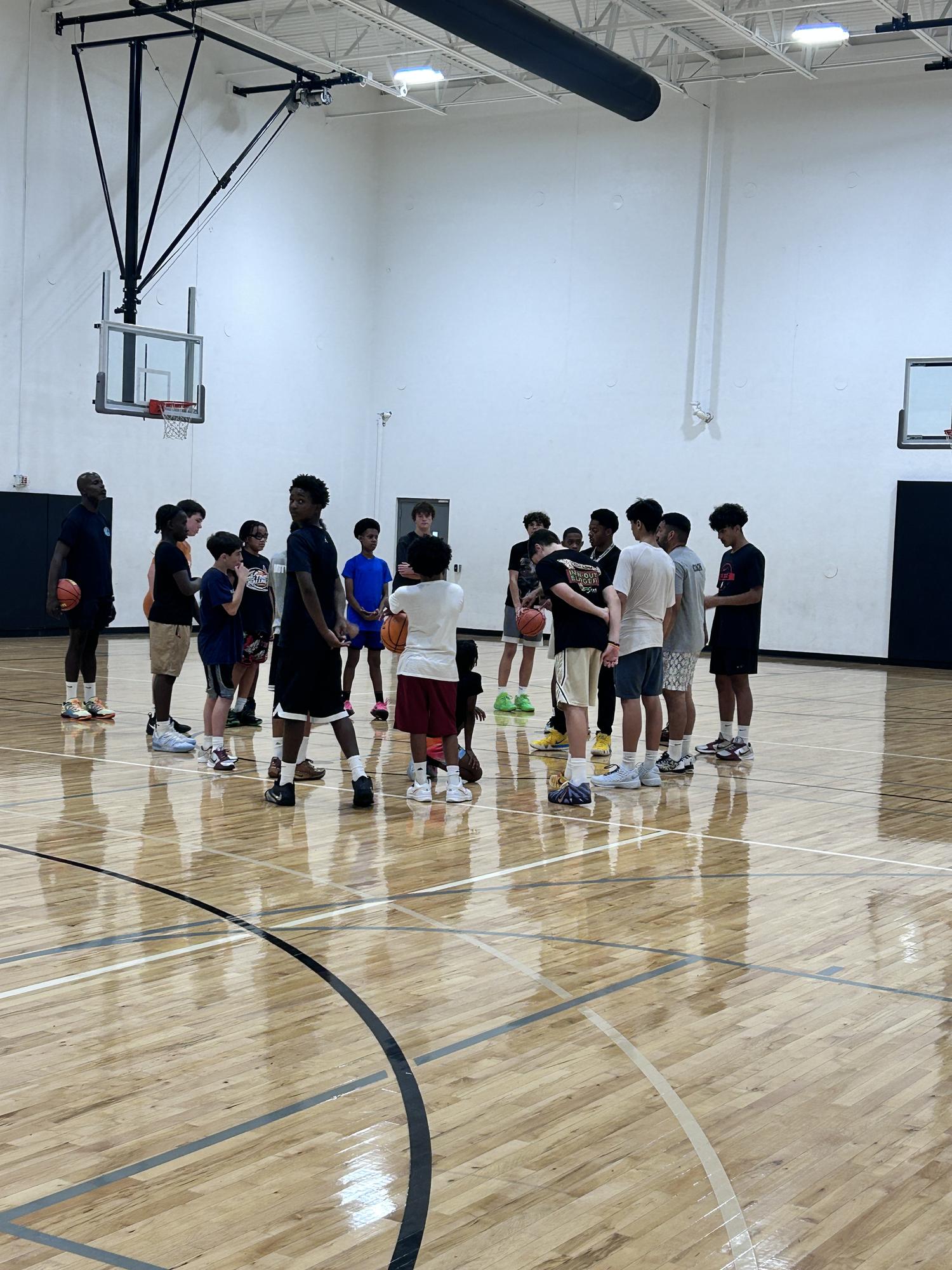 Youth basketball camp players lined up with basketballs on a Chicago gym floor