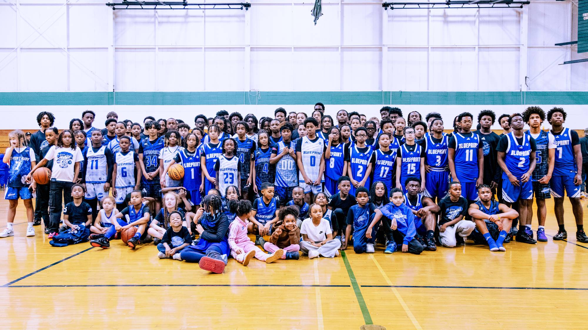 BLUEprint Hoops TRUE BLUE players in blue and white BLUEPRINT jerseys together on the court